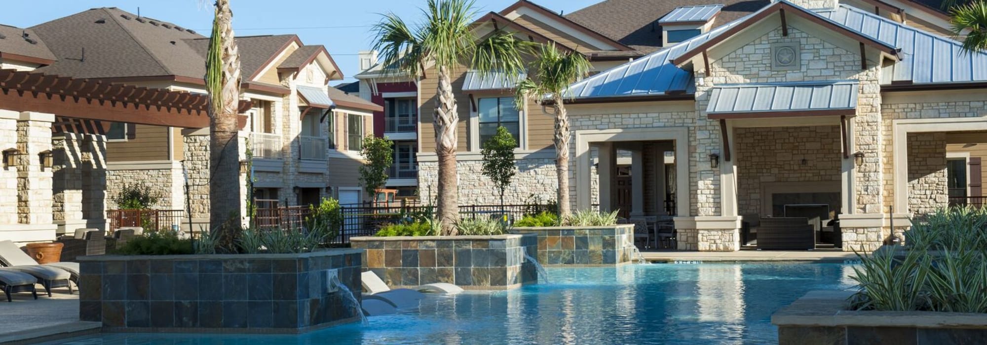 Shimmering pool with spigots at The Crossing at Katy Ranch in Katy, Texas