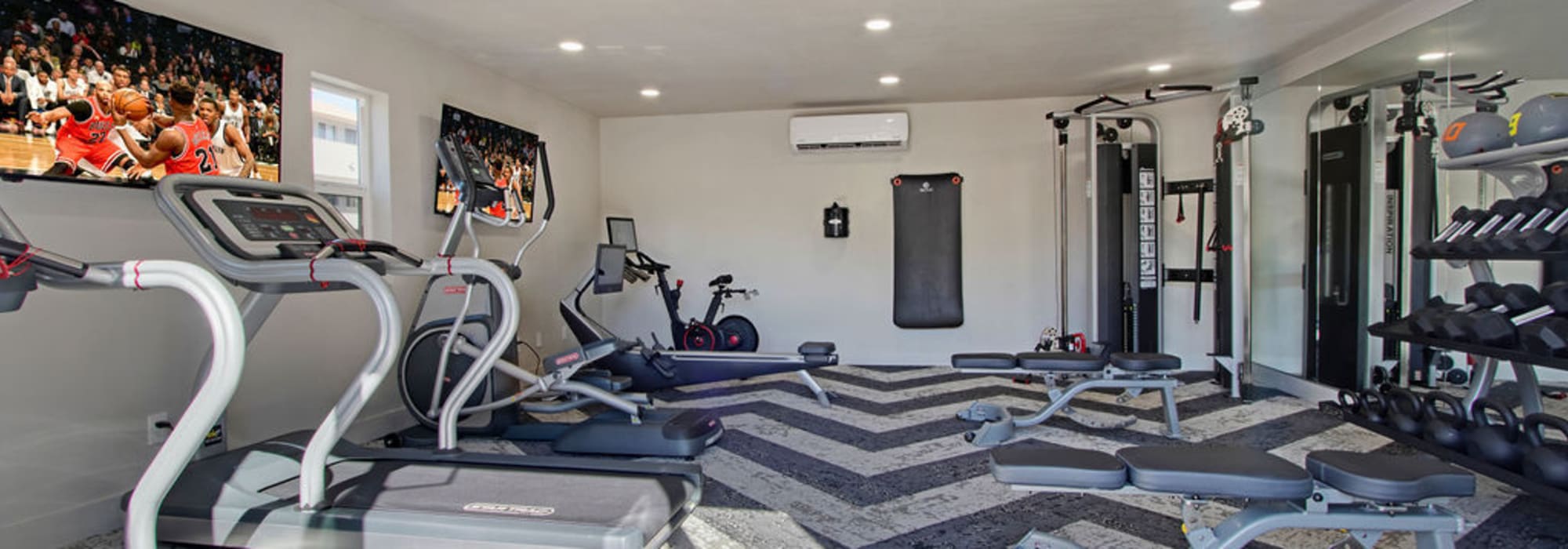 Gym with treadmills in the fitness center at Riverside Apartments in Tempe, Arizona