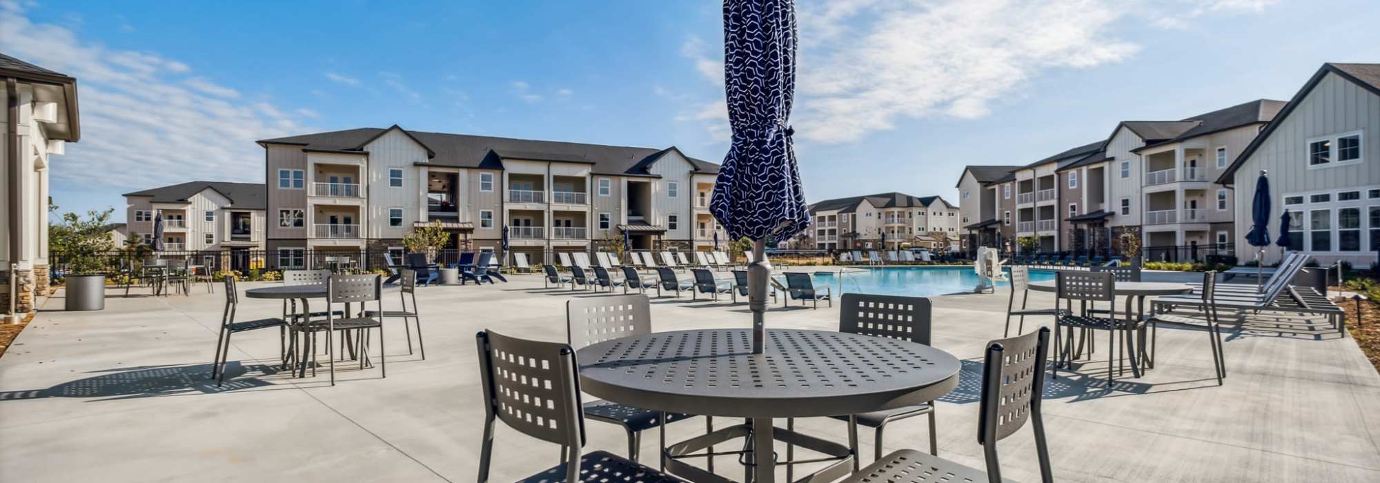Tables with umbrellas near our pool at The Standard at Pinestone in Travelers Rest, South Carolina