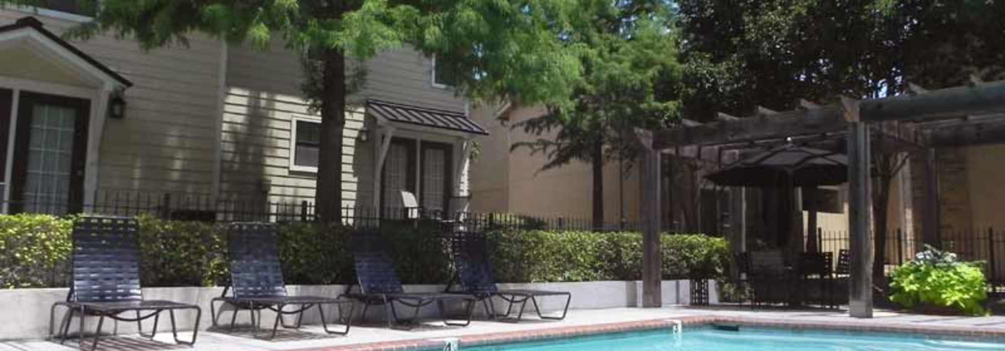 Resort-style swimming pool surrounded by lounge chairs at Highcrest in San Marcos, Texas