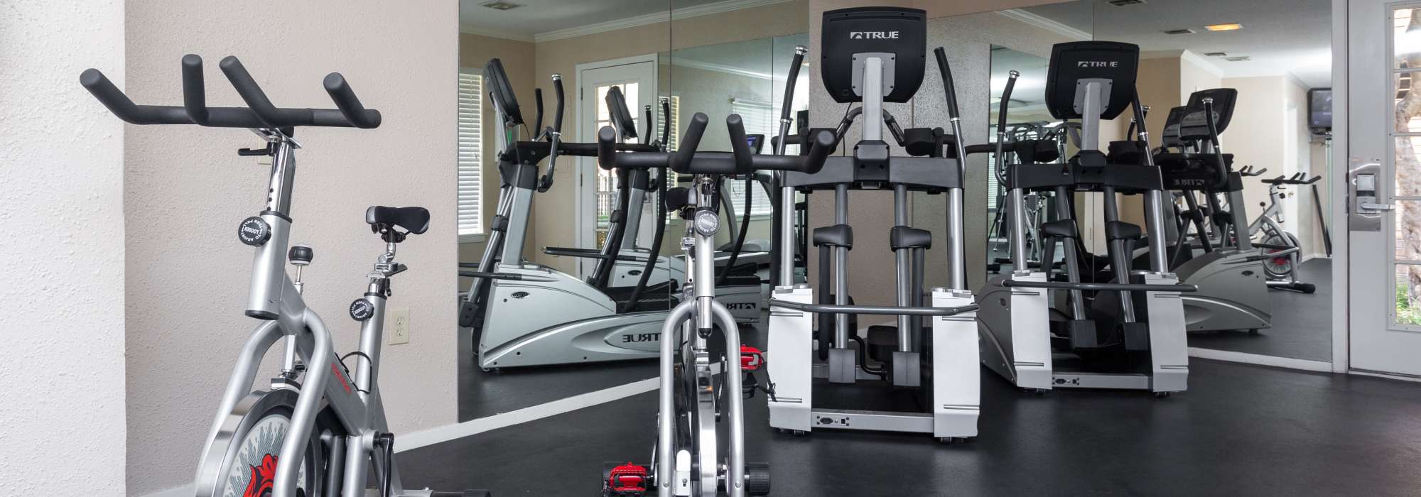 Fully-equipped gym with treadmills and weight machines at Greenacres Village in Bossier City, Louisiana