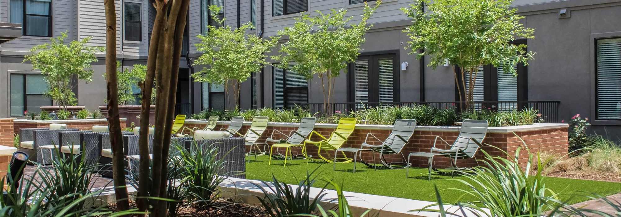 Outdoor relaxation area with multiple lounge chairs at Factory Design District in Dallas,Texas