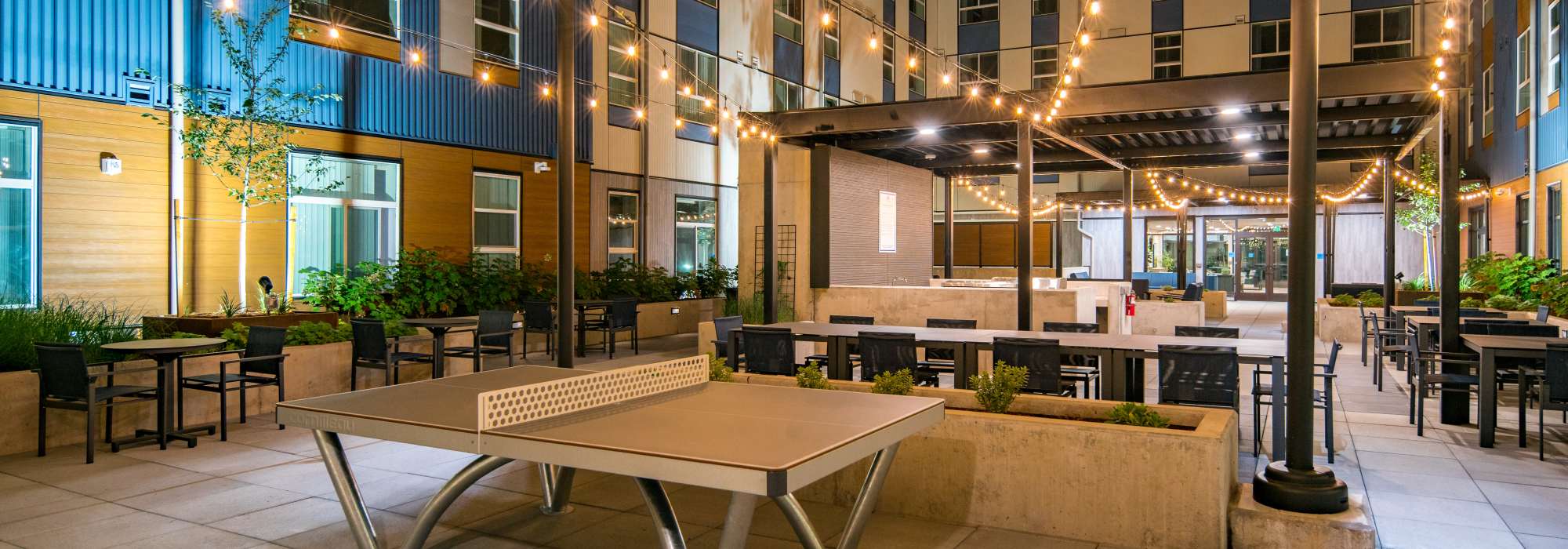 Photo of courtyard at night with ping pong table on Accessibility Statement | Traditions at Hazelwood in Portland, Oregon