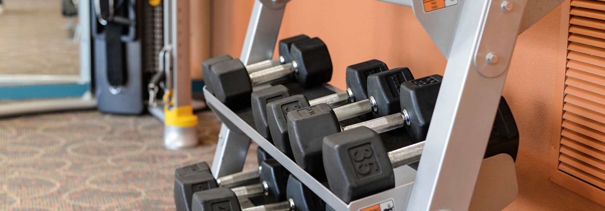 Free weight station in fitness center at UTE Creek Apartments in Longmont, Colorado