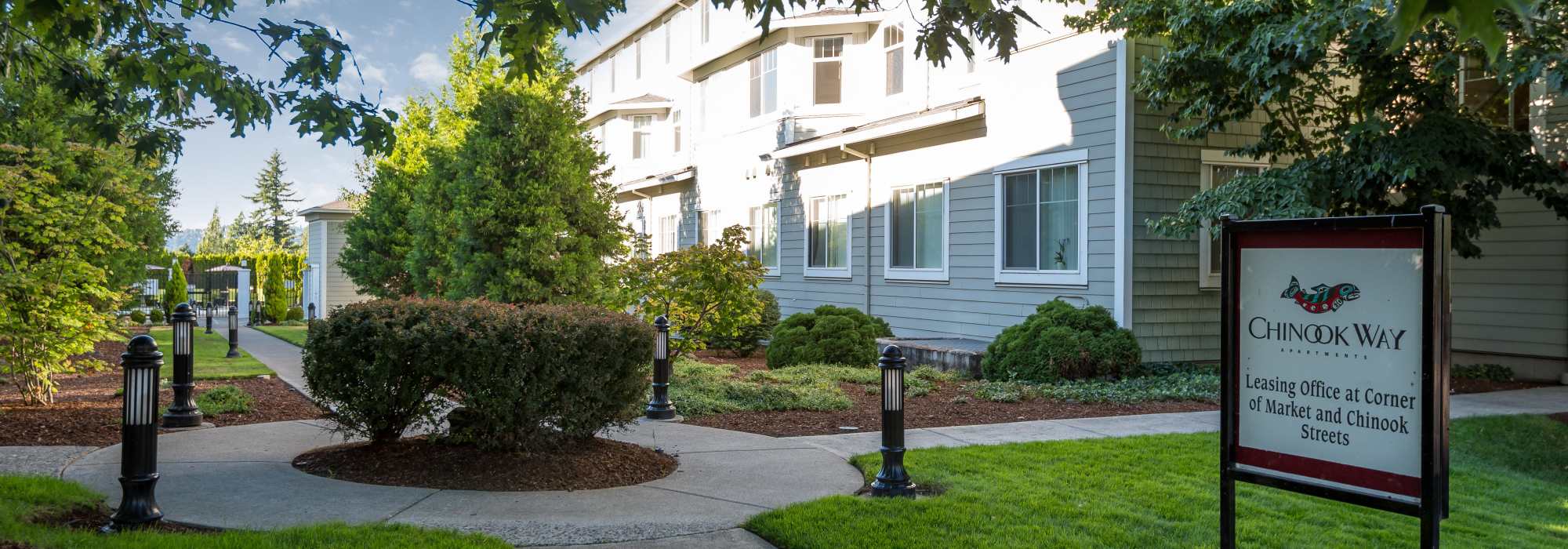 Community exterior view with signage at Chinook Way Apartments in Fairview, Oregon  