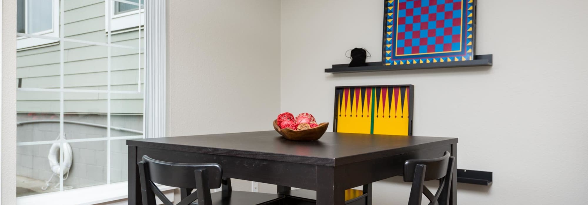 Clubhouse with dinning table and chair at Chinook Way Apartments in Fairview, Oregon