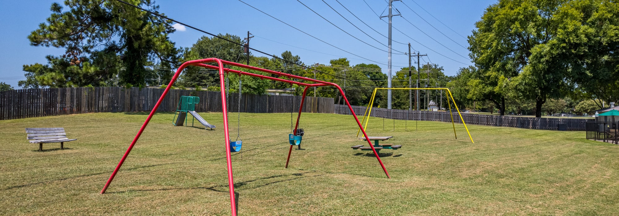 Playground with swing at Millbrook Apartments in Shreveport, Louisiana