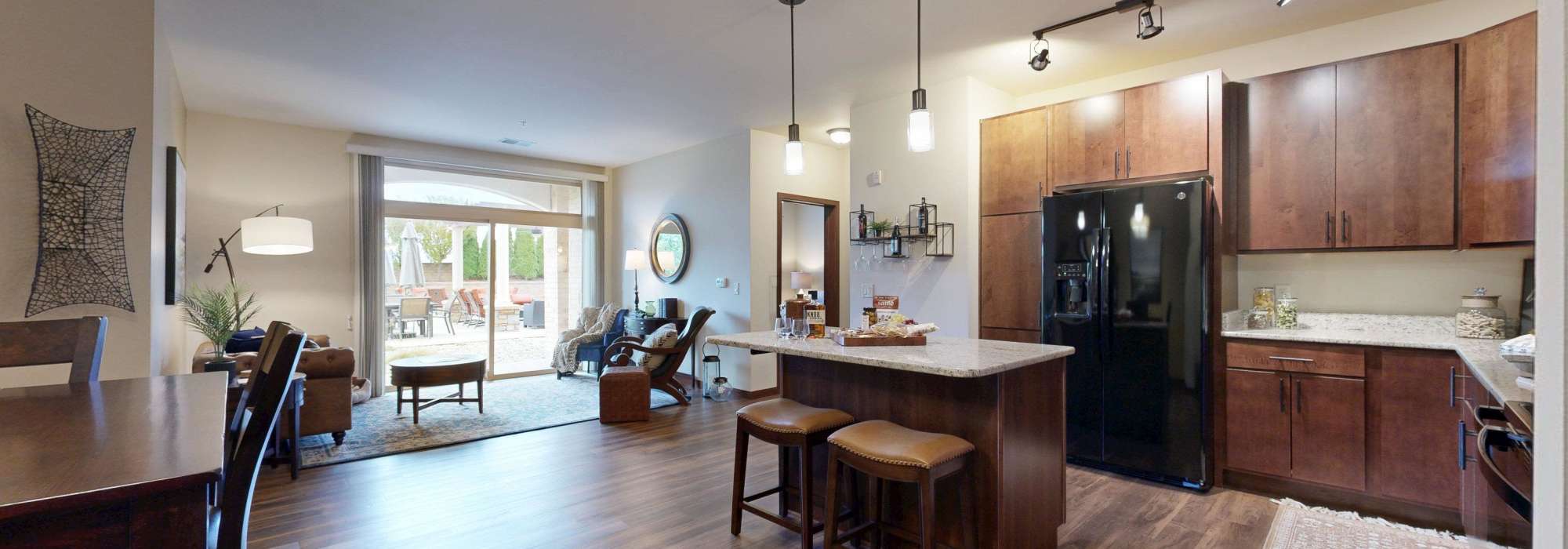 Kitchen with living room at The Tuscany On Pleasant View in Madison, Wisconsin
