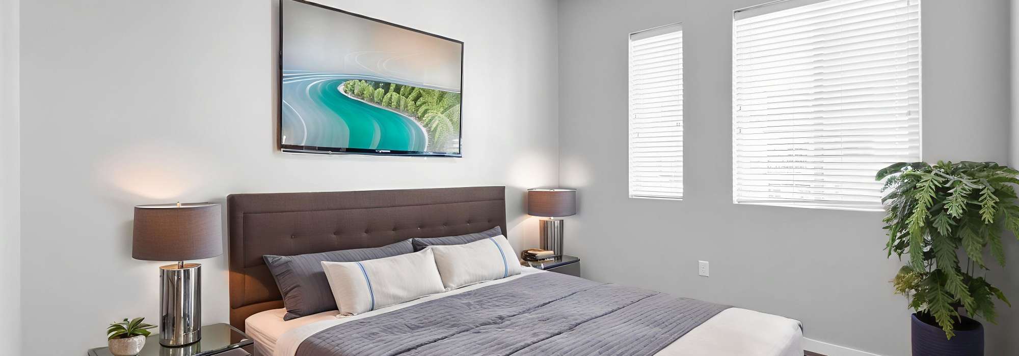 Modern bedroom with large windows at Cityville on 9th in Des Moines, Iowa