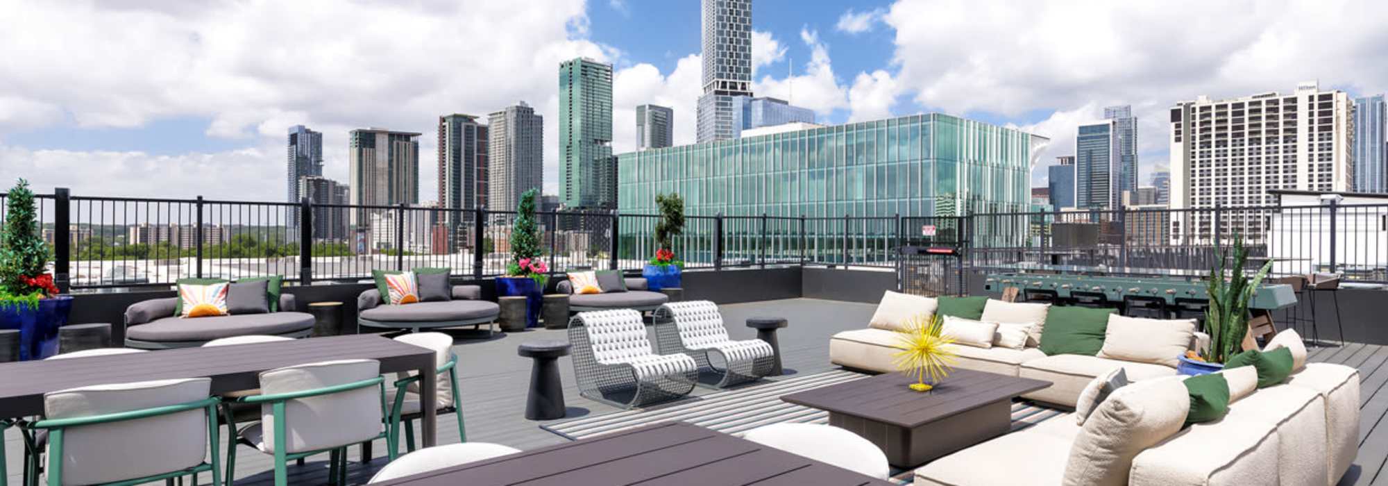 Rooftop lounge with city skyline views and vibrant planters at Corazon in Austin, Texas