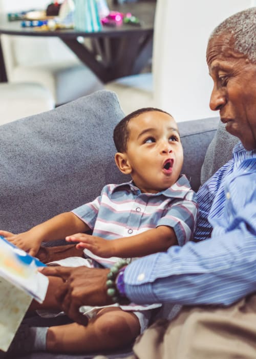 A resident holding his grandson at Grand Villa Senior Living in Clearwater, Florida