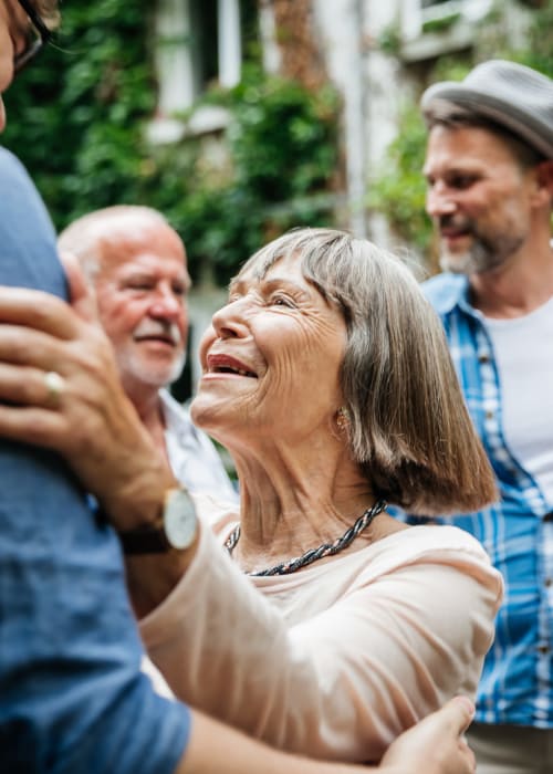 A happy resident dancing at Grand Villa of Clearwater in Clearwater, Florida