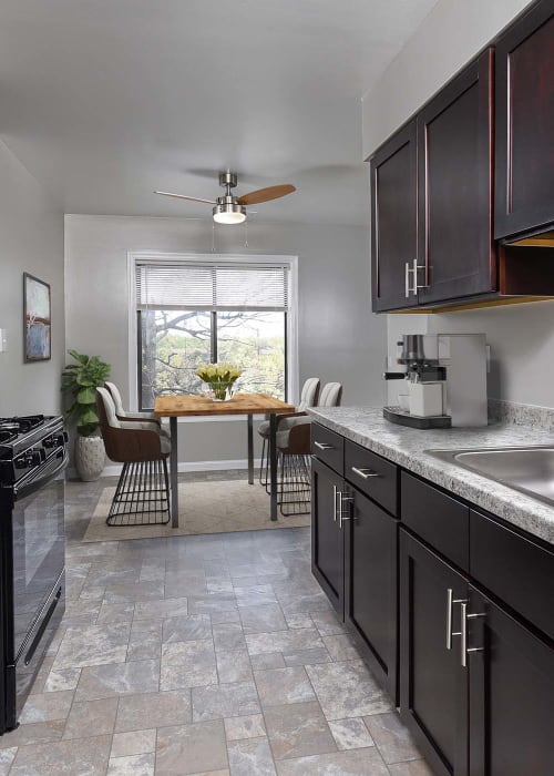 Kitchen with black appliances and granite countertops at The Flats at Columbia Pike in Silver Spring, Maryland