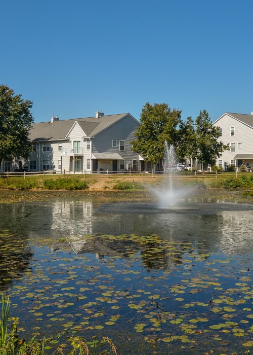 Water fountain in middle of small lake at Stonegate Apartments in Elkton, Maryland