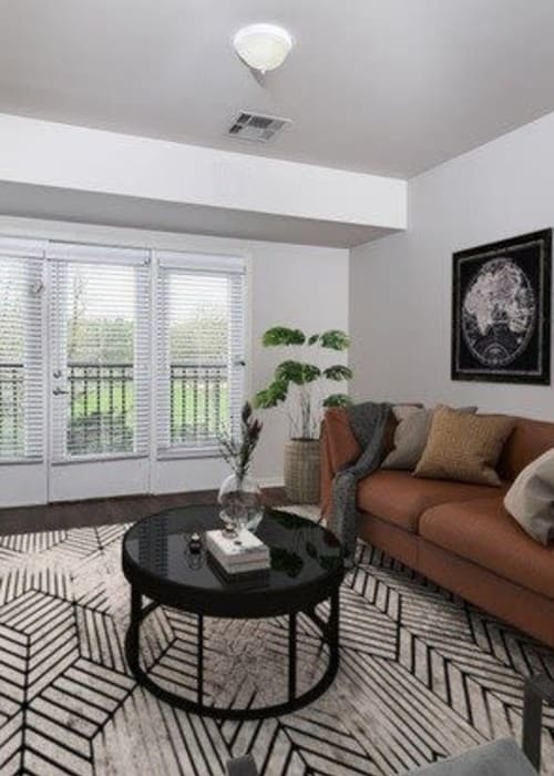 Modern living room with leather couch at Parc at Maplewood Station in Maplewood, New Jersey