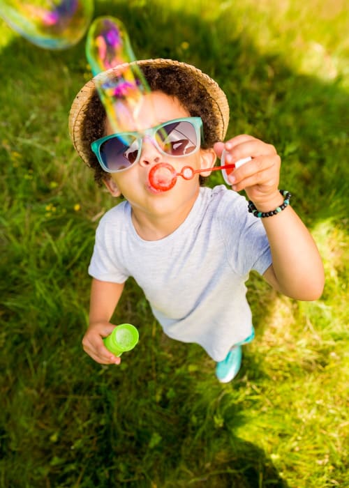 Kid blowing bubbles at St. Johns Landing Apartments in Green Cove Springs, Florida