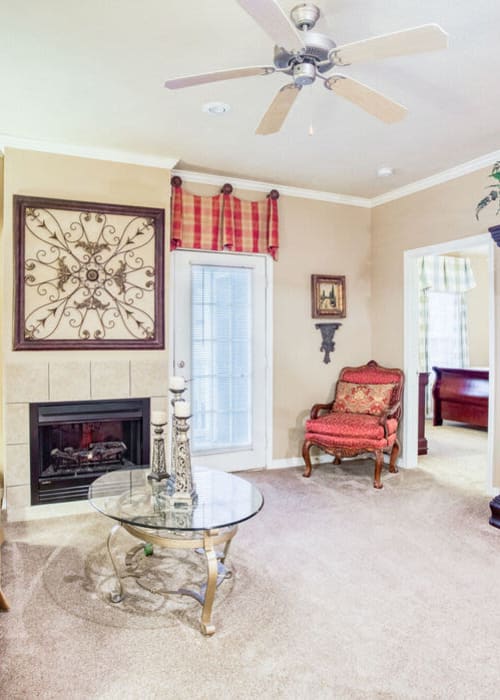 Model living space with red accents at Villages of Cross Creek in Rogers, Arkansas