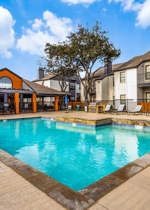 Residents enjoying the pool at Knowlton Apartment Homes in Mesquite, Texas