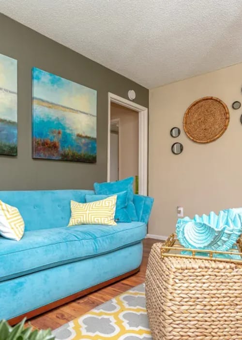 A furnished apartment living room with a painted accent wall at Fairway View in Hialeah, Florida