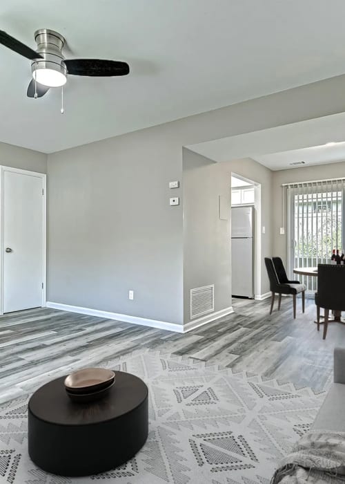 Living room with a comfortable couch, coffee table and a dining area with a table and chairs at Woodside Village in Valparaiso, Indiana