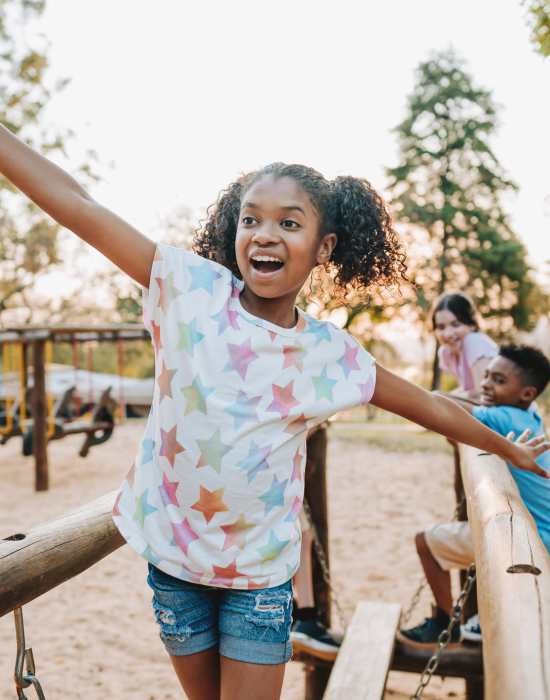 Kids playing in playground with slides at The Indie Glendale Collection in Glendale, California