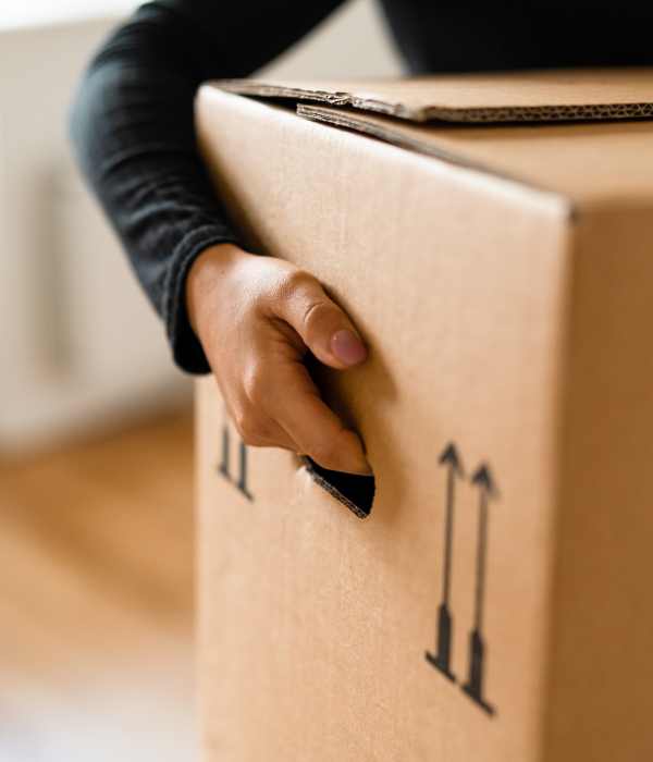 A customer holding a packed box at Storage Hub - Redland in San Antonio, Texas