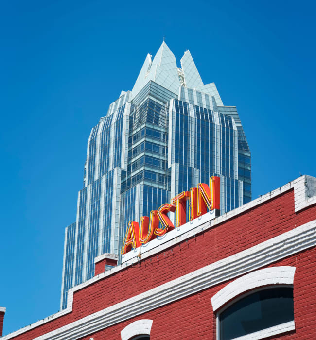 Austin sign on building with skyscraper in background near The 704 in Austin, Texas