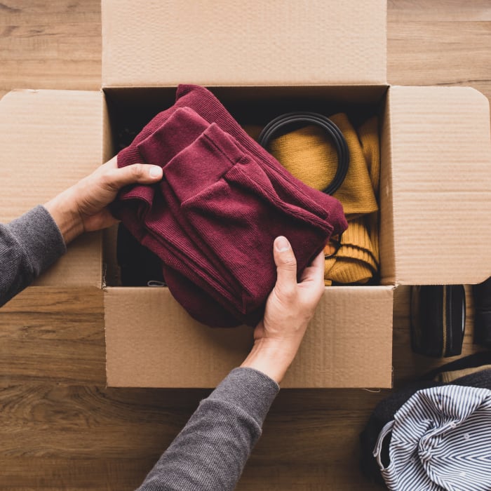 Person packing sweaters into box near YourSpace Storage @ Bayside in Frankford, Delaware