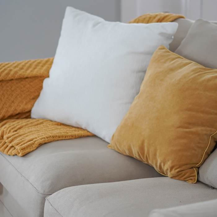 Cozy living room with decorative pillows at Villas at Mulberry Way in Kalamazoo, Michigan