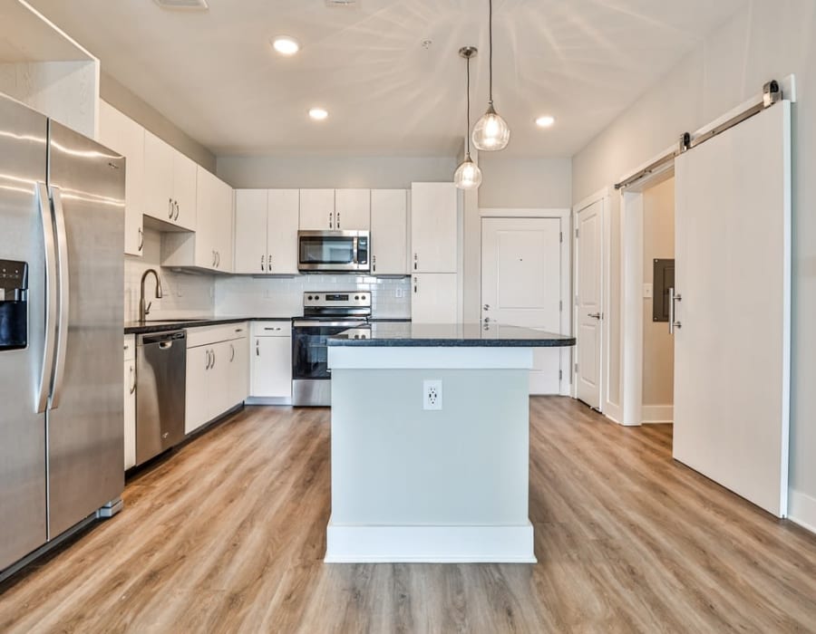 Apartment kitchen with an island at The Rey on Reynolds in Duluth, Georgia