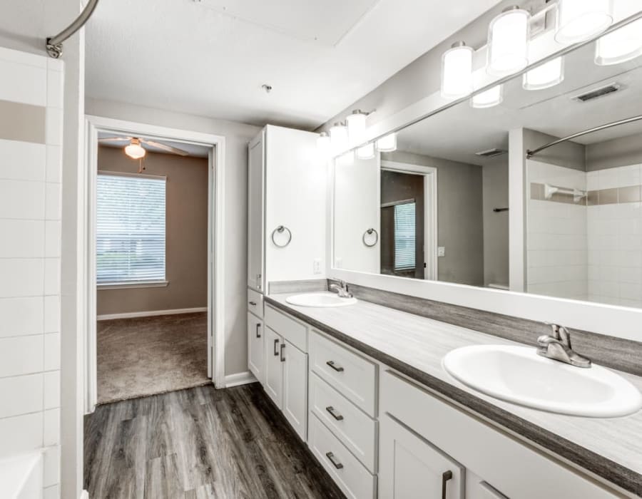An apartment bathroom at Compass at Windmill Lakes in Houston, Texas