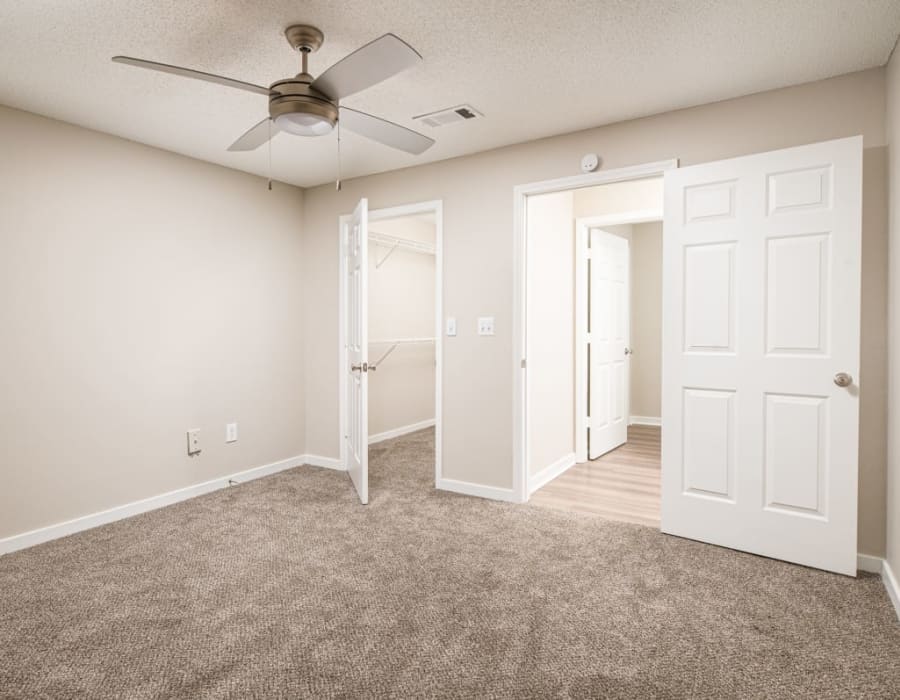 Apartment master bedroom with carpeted floor at The Crescent at 161 in Walls, Mississippi