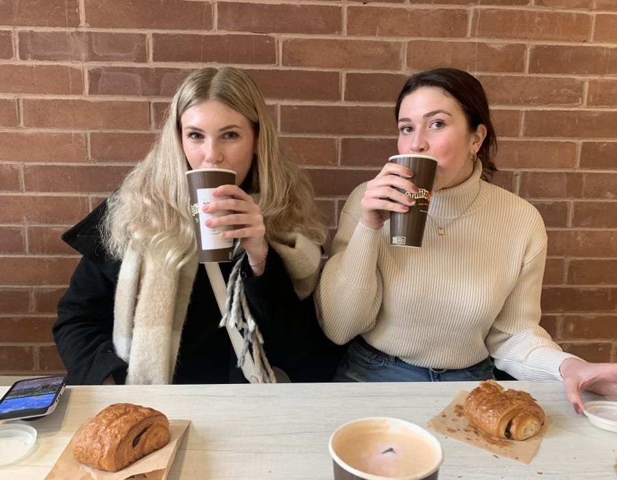 Friends enjoying coffee and pastries at a CLS Society event at Campus Life & Style in Austin, Texas