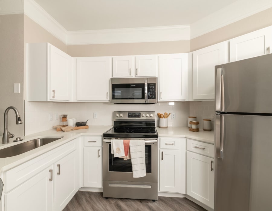 Kitchen with stainless steel appliances at The Spencer Park Row in Houston, Texas