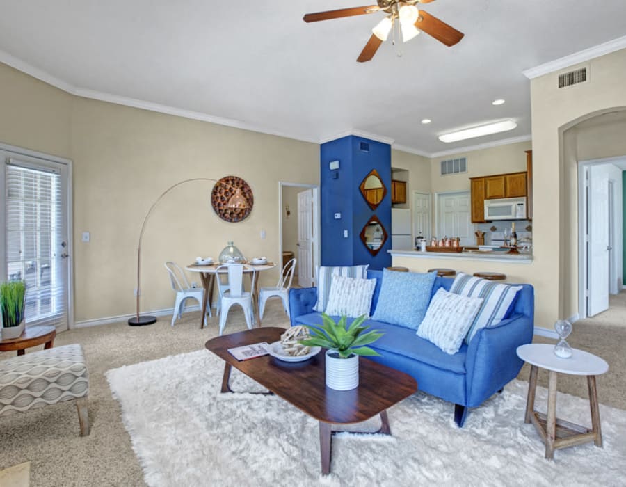 Model living space with blue accents at The Anthony at Canyon Springs in San Antonio, Texas