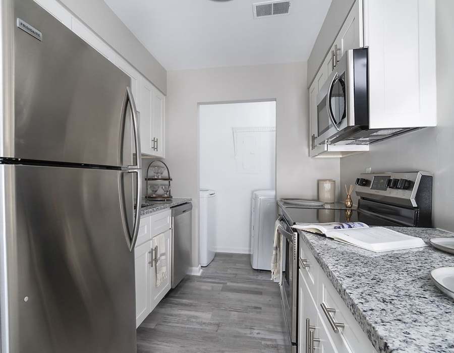 Hallway apartment kitchen at Acasă Orchard Park Apartments in Greenville, South Carolina