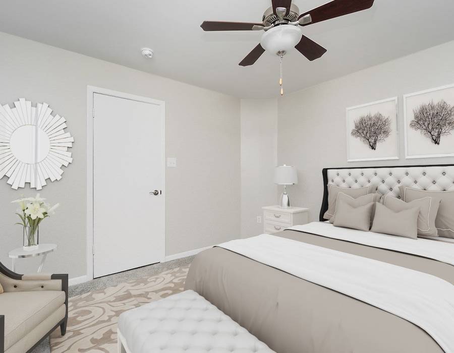 Model apartment bedroom with a ceiling fan at Acasă Orchard Park Apartments in Greenville, South Carolina
