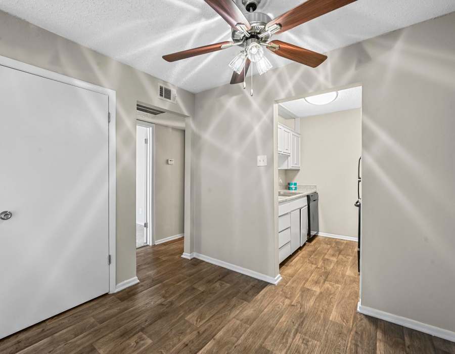 Bright living room with ceiling fan atFinley Square in Irving. TX