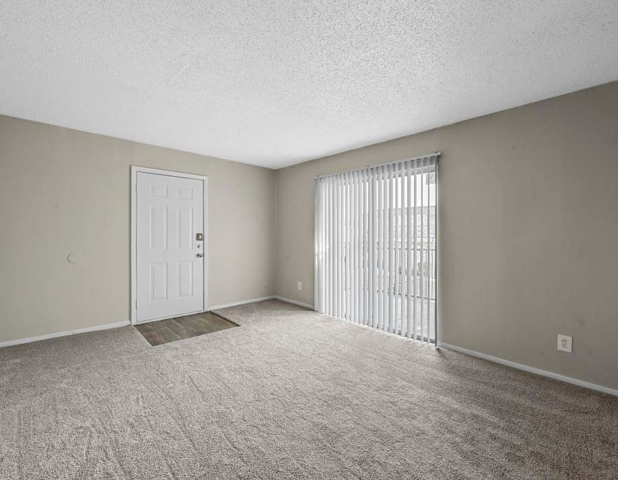 Bright bedroom with an opening door atFinley Square in Irving. TX