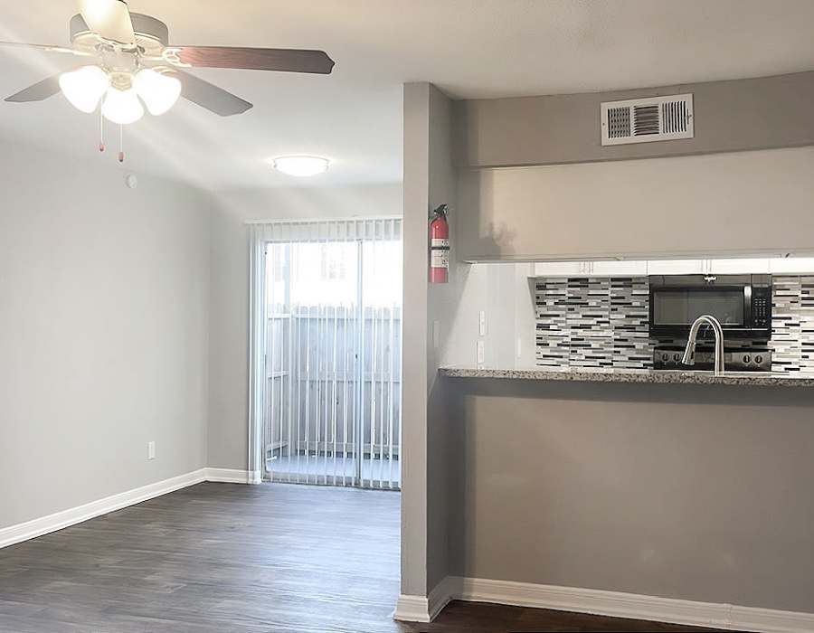 Fully-equipped kitchen island with direct access to patio at Oaks of Wimbledon in Spring, Texas, 