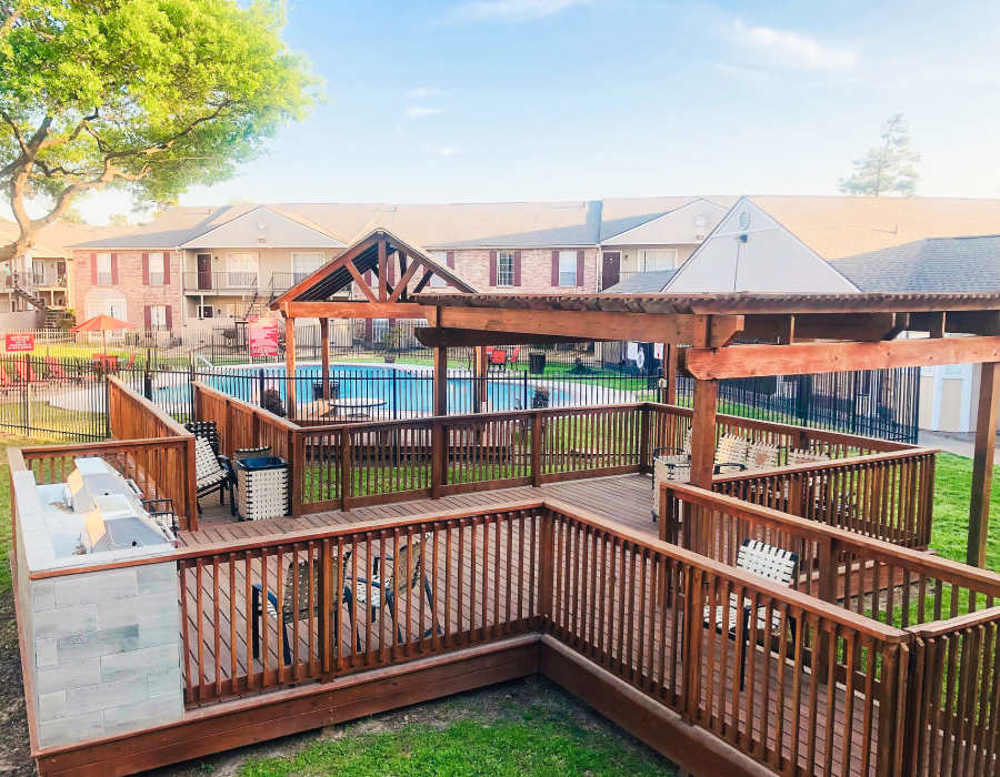 Community park with lots of grass, tables and barbecues at Oaks of Wimbledon in Spring, Texas, 