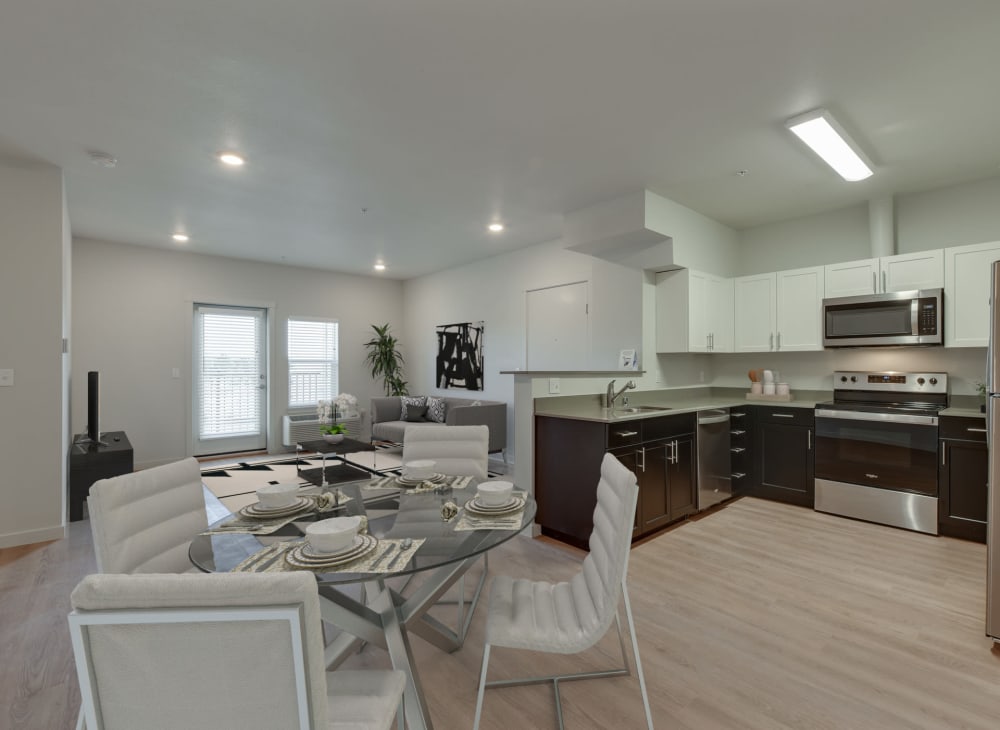 Sleek modern kitchen, dining room and living room at Kestrel Park in Vancouver, Washington