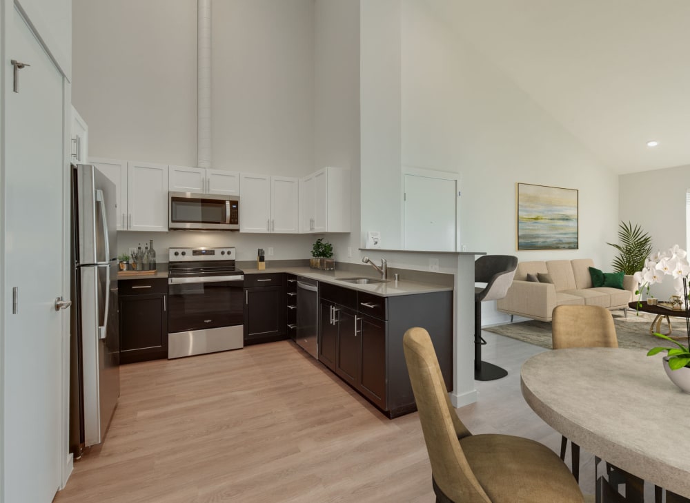 An apartment's full kitchen with modern furnishings at Kestrel Park in Vancouver, Washington