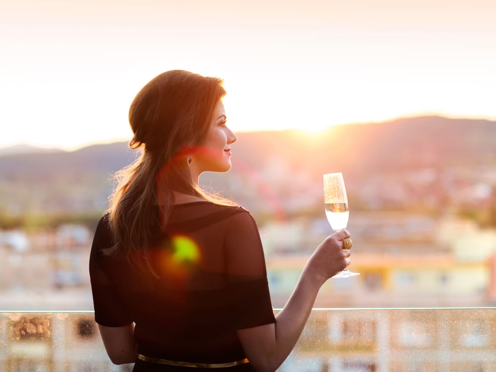 Resident drinking wine from the balcony at Mira Santi in Chandler, Arizona