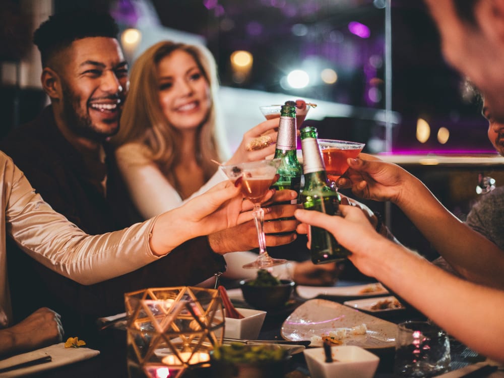 Friends celebrating over drinks near BB Living at Higley Park in Gilbert, Arizona