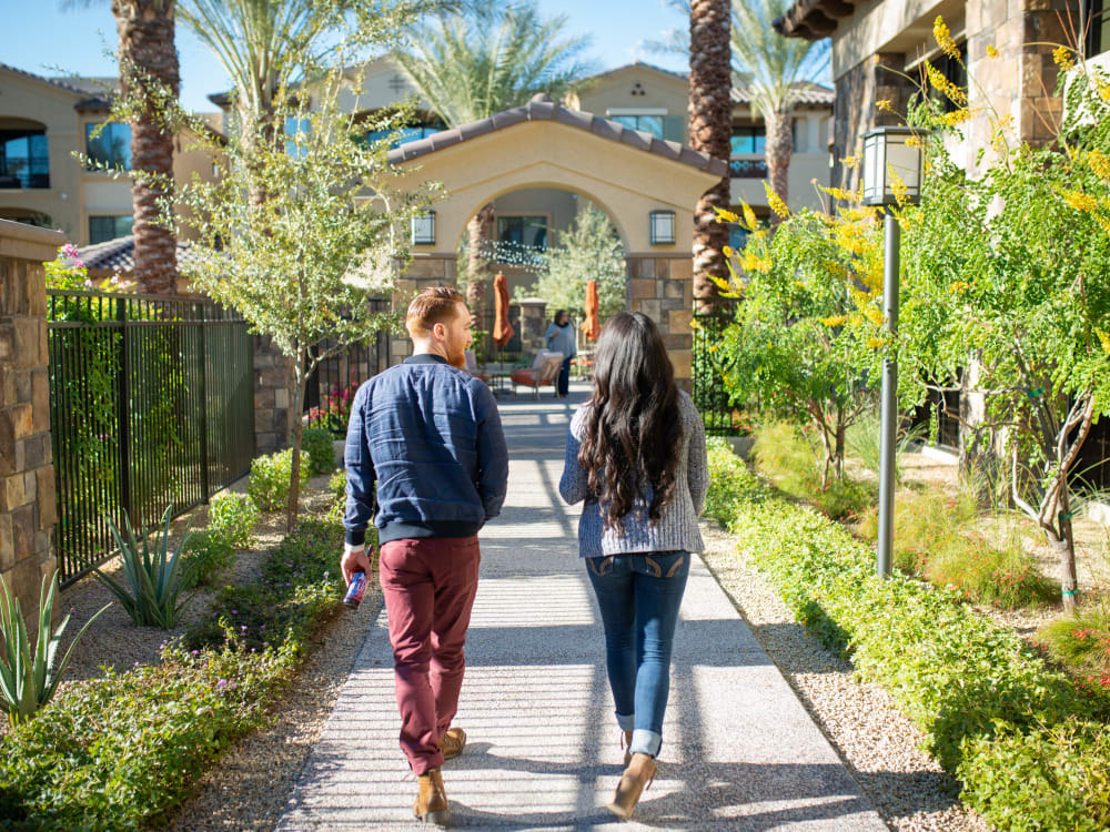 Residents walking the beautifully maintained grounds at San Valencia in Chandler, Arizona