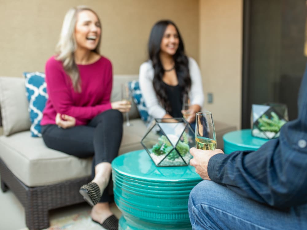 Residents friends enjoying drinks on their private patio at The Hyve in Tempe, Arizona