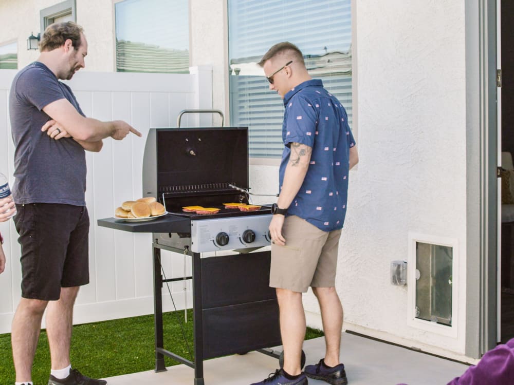 Residents enjoying grilling on their private patio at Christopher Todd Communities on Camelback in Litchfield Park, Arizona