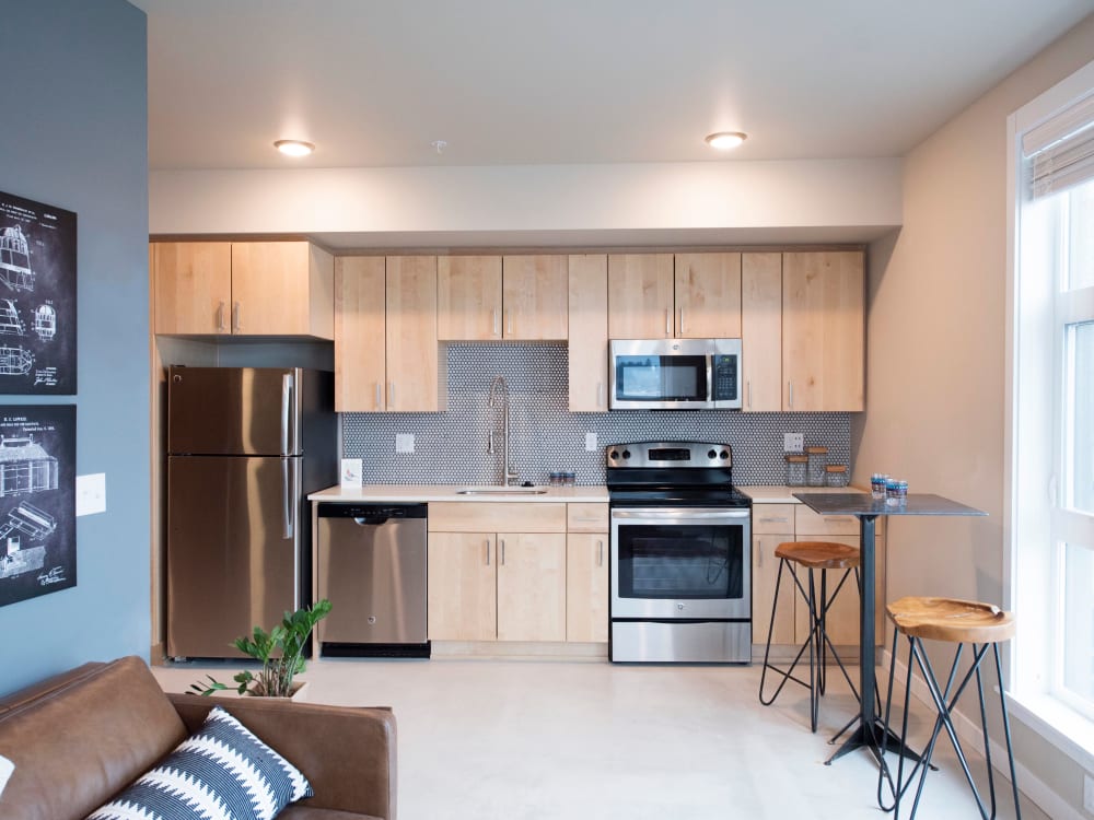 Accent wall in the living space next to the kitchen in an open-concept model home at Brooklyn Yard in Portland, Oregon