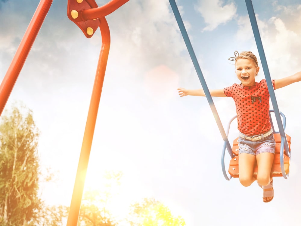 Kid on a swing at TerraLane on Cotton in Surprise, Arizona